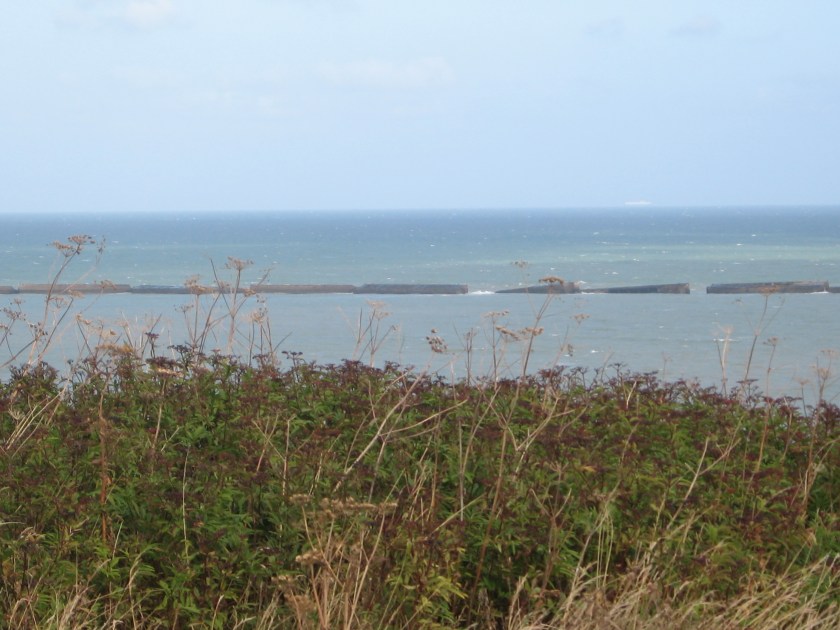 Gold beach with remains of harbor